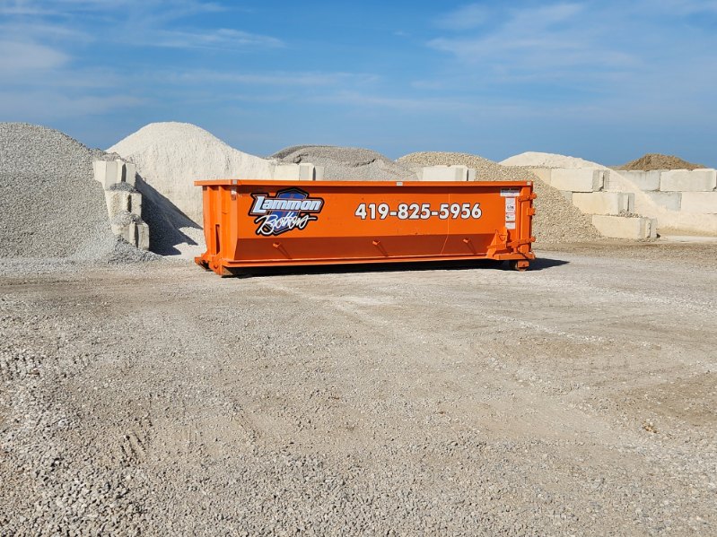 Orange Lammon Bros 15-yard roll-off dumpster with the 419-825-5956 number, staged at our Delta yard