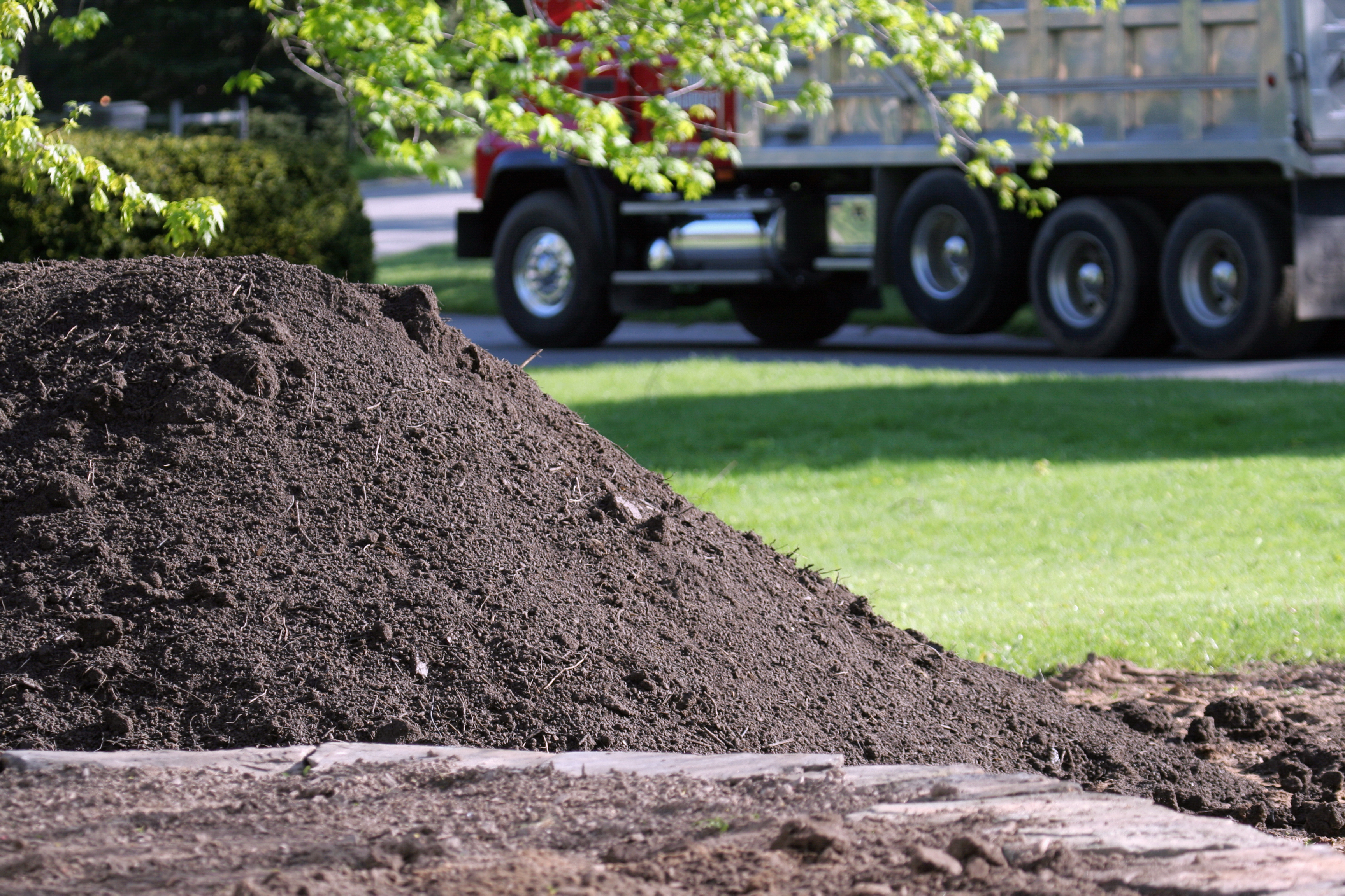 Large mound of dark screened topsoil