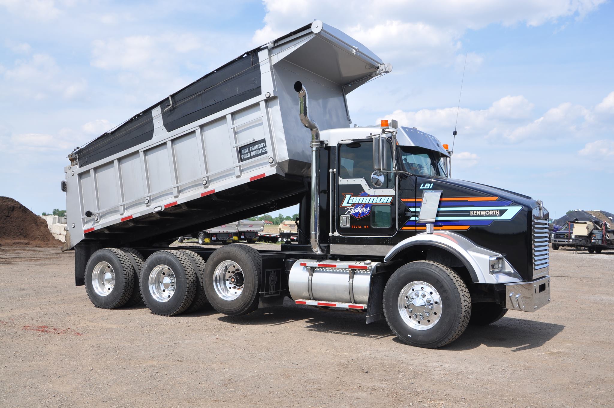 Black and silver Lammon Bros Kenworth tri-axle dump truck