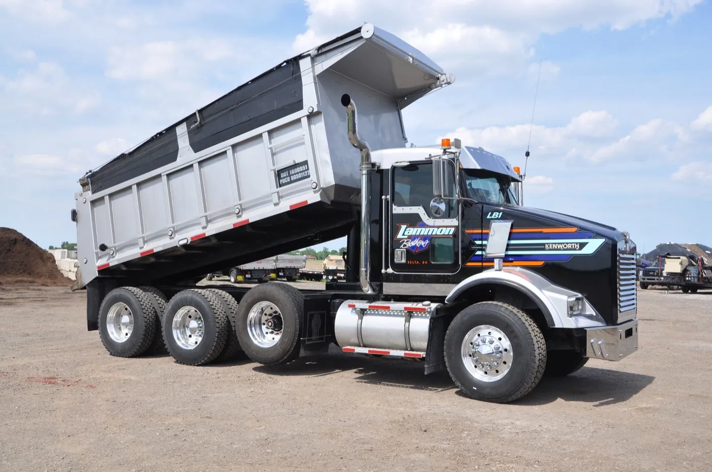 Black and silver Lammon Bros Kenworth tri-axle dump truck